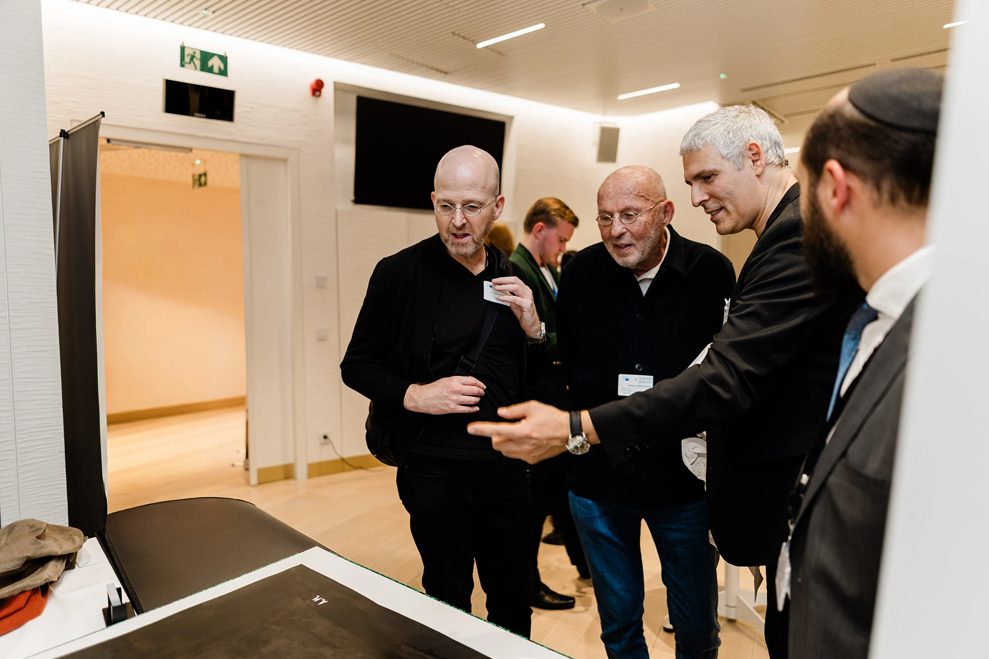 Guests discussing one of the works with Alexandre Mitchell