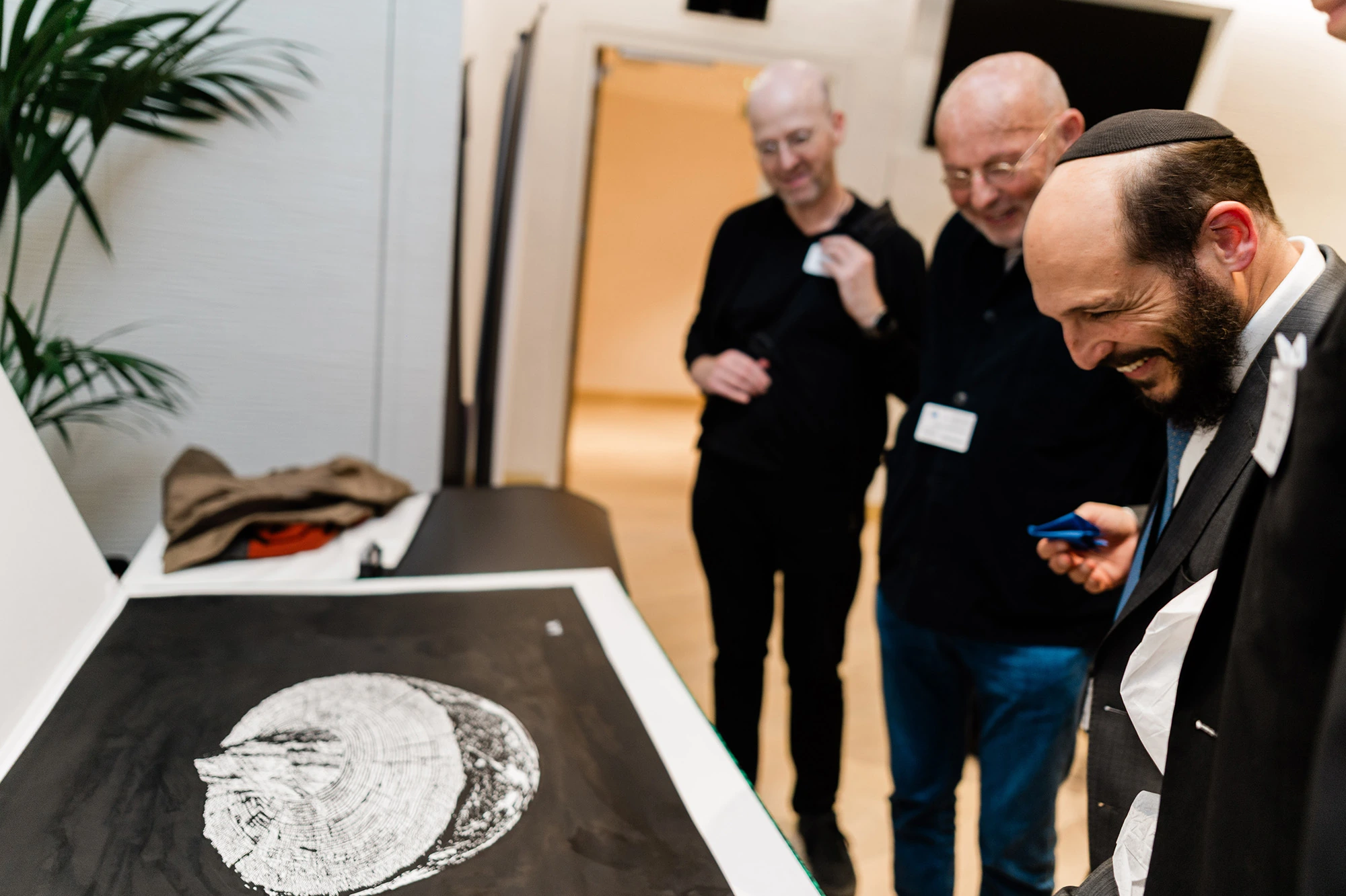 Guests looking closely at a lithograph