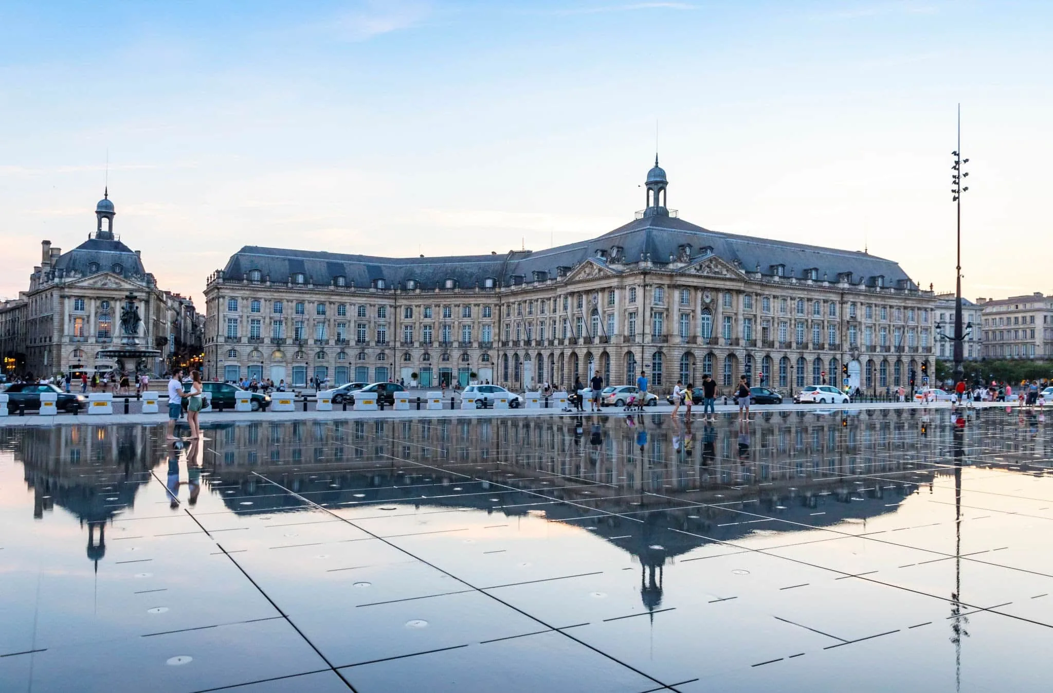 Children and visitors around the Miroir d’eau opposite the Place de la Bourse in Bordeaux