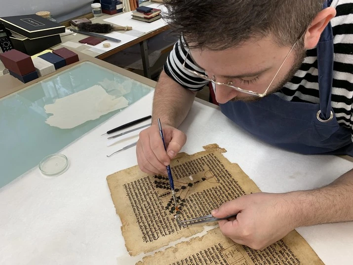 Conservator working on a sixteenth-century Yemenite manuscript of Maimonides' Commentary on the Mishnah